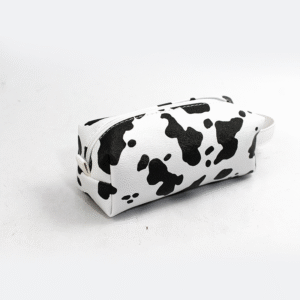 A chic cosmetic bag adorned with a black and white cow print pattern.