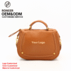 Tan rounded handbag with top handle and shoulder strap